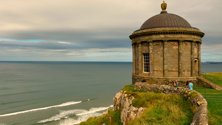 Visitors walking along the clifftops at Downhill Demesne and Hezlett House with Mussenden Temple, Country Londonderry